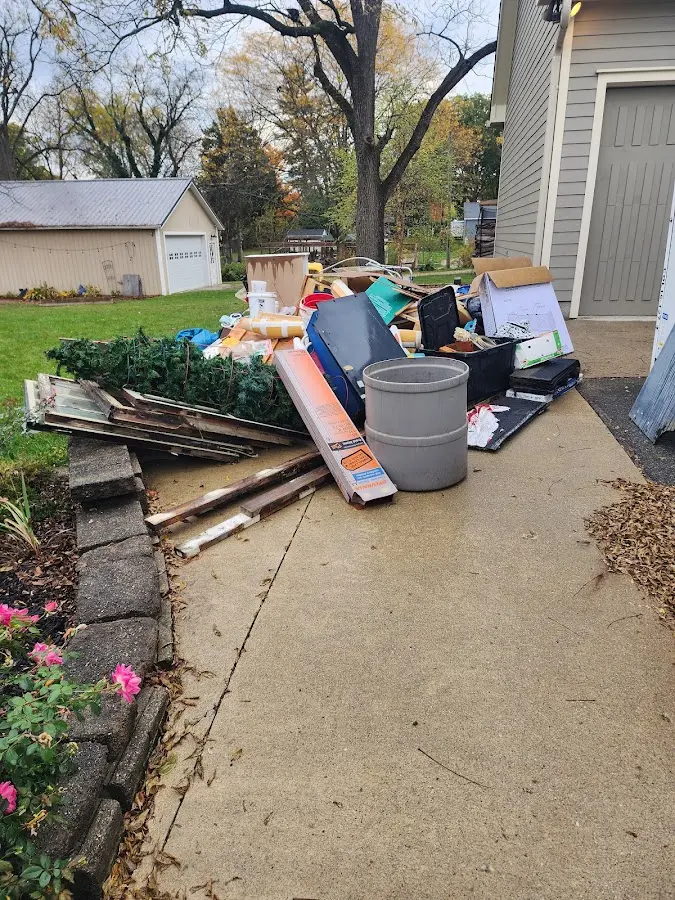 Dumpster being loaded with debris for Estate Cleanout Dumpster Rental in Chadds Ford
